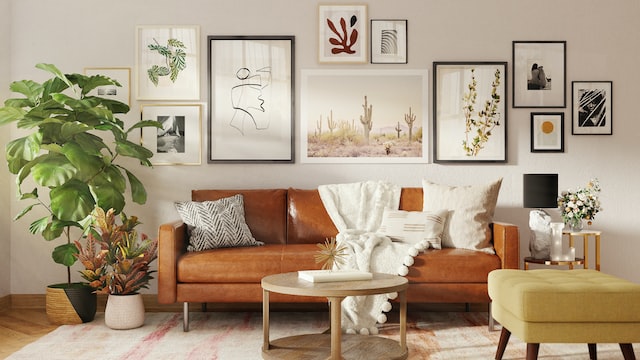 living room with light brown leather couch and gallery wall with paintings in different sized frames